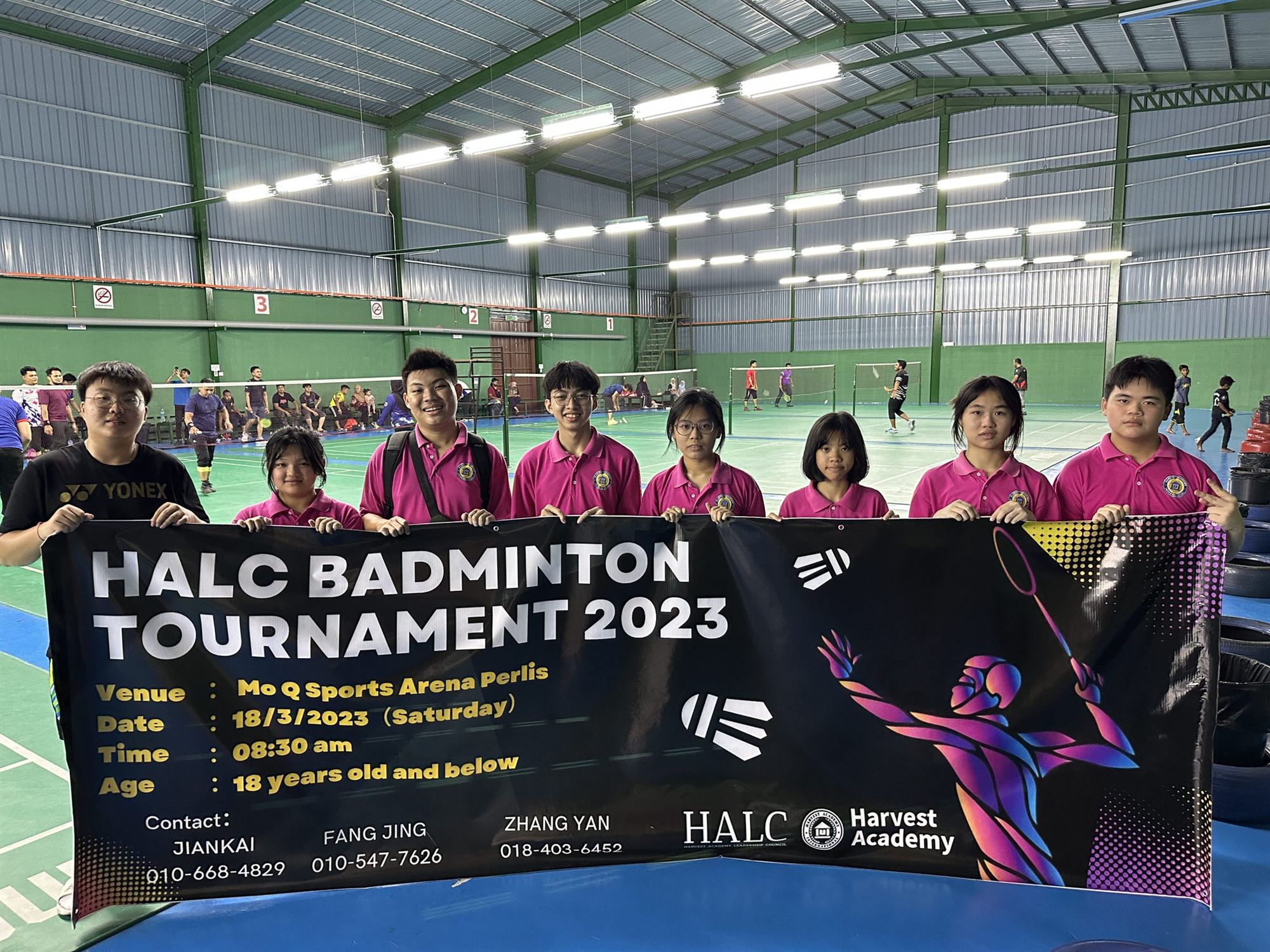 HALC Badminton Tournament participants with the event banner