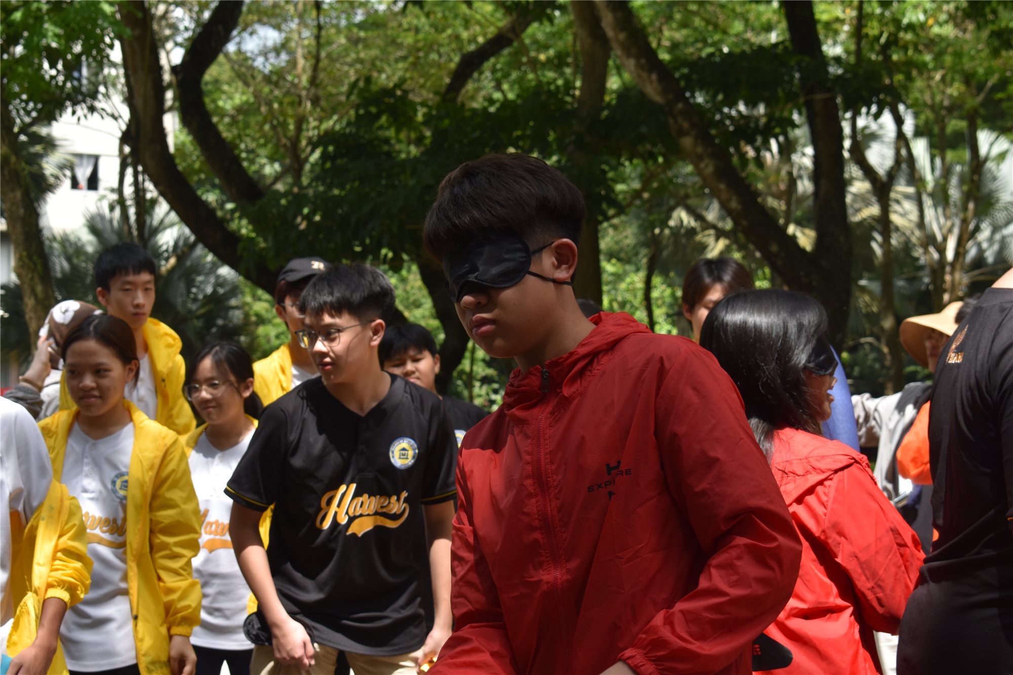 A blindfolded Harvest Academy student guided by classmates in an H-Explore trust activity