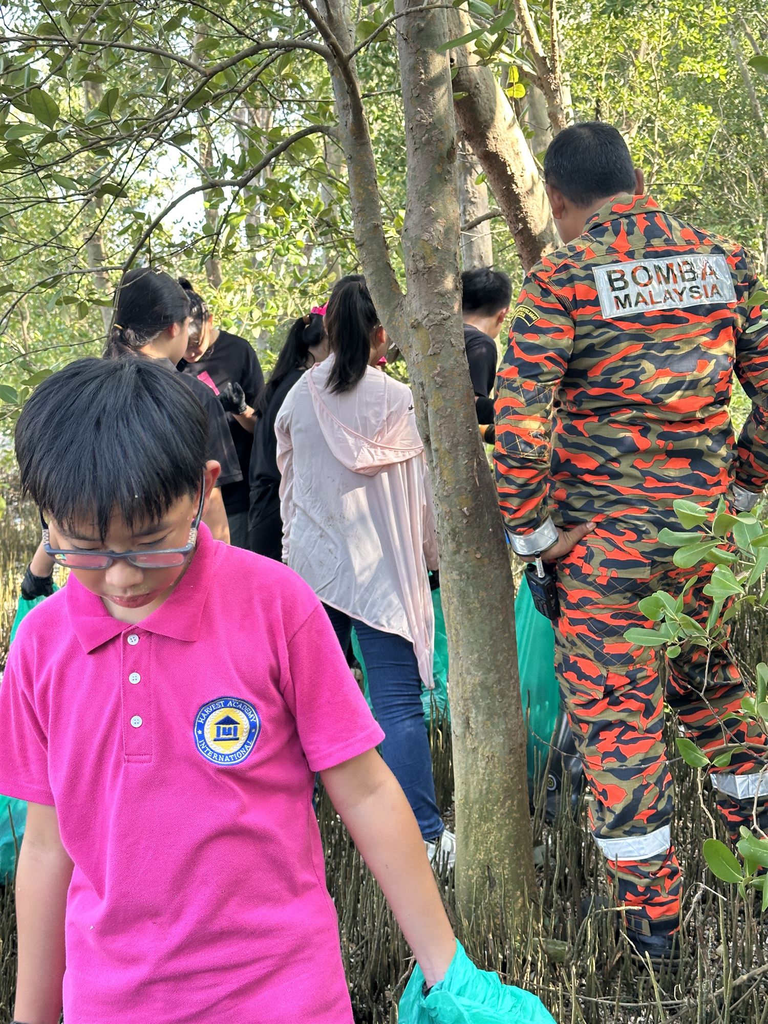 Student planting a mangrove sapling